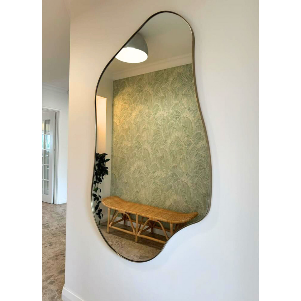 Organic shaped pebble mirror in brass